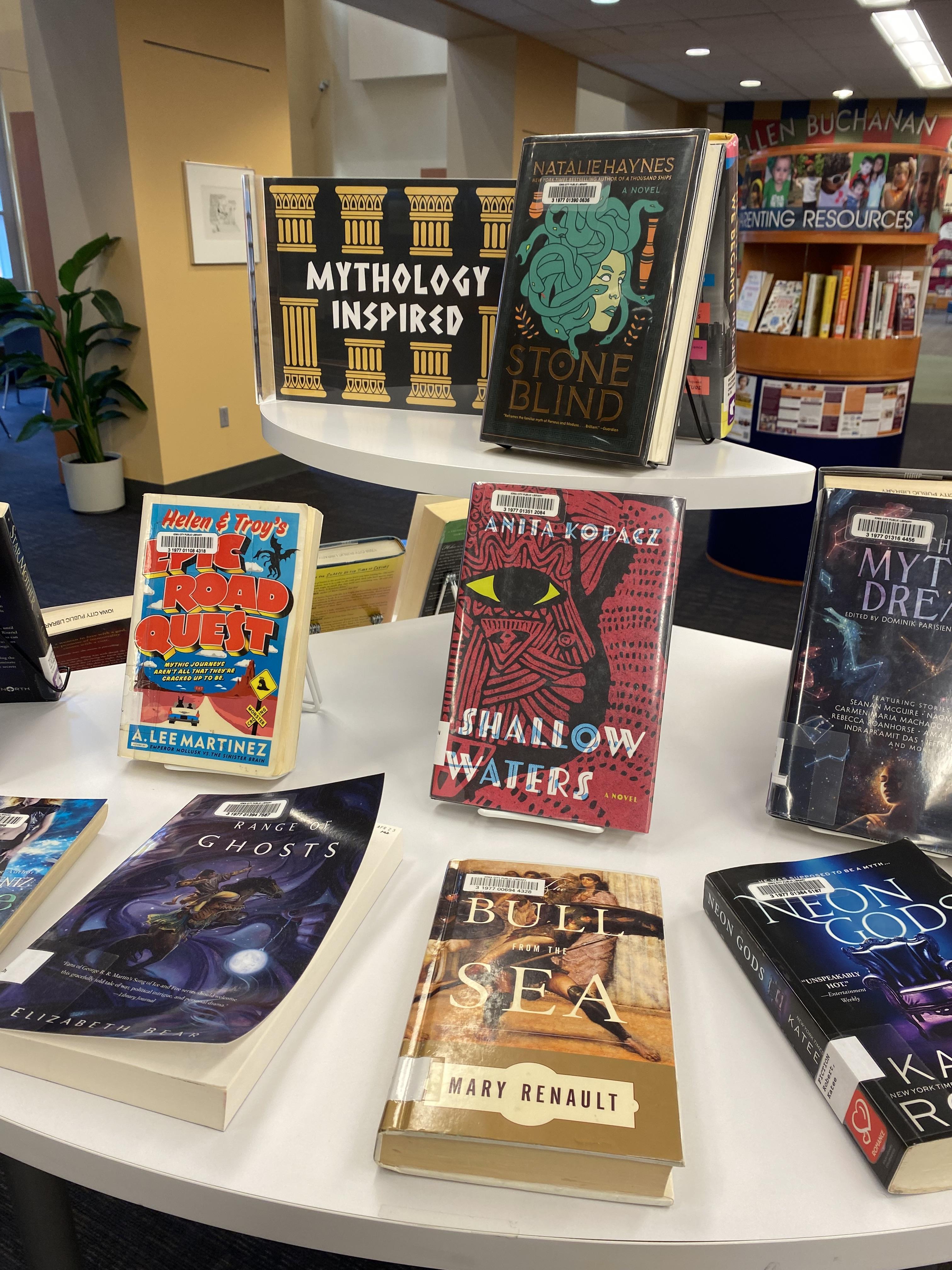 Books on Mythology Inspired fiction display include titles by Elizabeth Bear, Anita Kopacz, Mary Renault, A. Lee Martinez, and Katee Robert. 